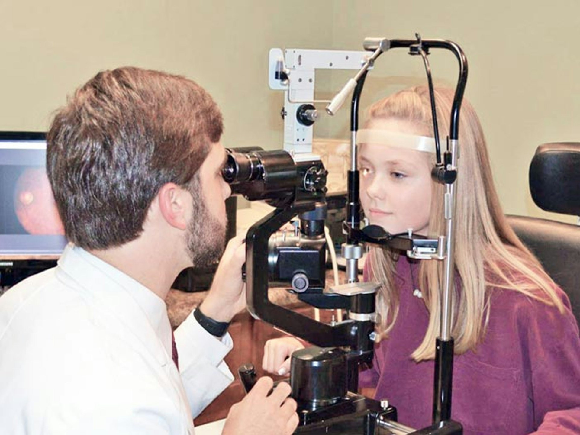 A man and a woman looking through a camera